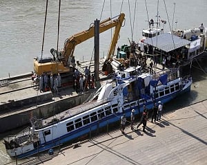 Crane lifts sunken tour boat out of Danube River