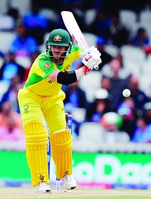 Indian bowlers put squeeze on Warner