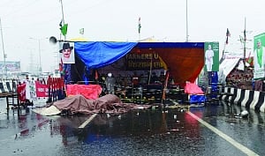 Farmers brave cold as rain ruins tents, blankets