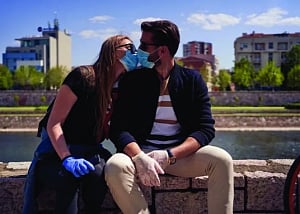Is it safe to mask kiss in a partially-vaccinated world?