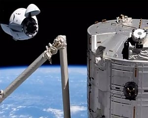 Old SpaceX capsule delivers new crew to space station