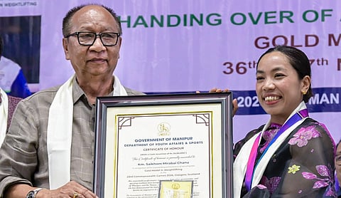 Manipur Chief Minister Y Khemchand Singh with Commonwealth Games gold medallist and Olympic silver medallist Saikhom Mirabai Chanu during an event in Imphal on August 22. | Photo: PTI