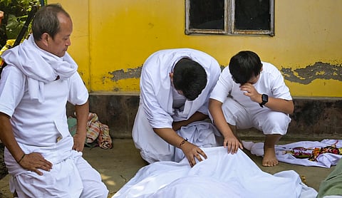 Family members perform the final rites of slain Manipuri musician Chongtham Vikram Singh at his home in Imphal. PTI photo