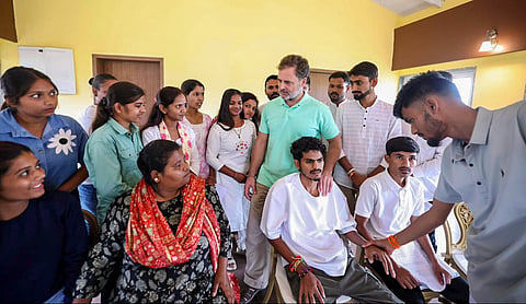 Leader of Opposition in the Lok Sabha Rahul Gandhi interacts with a delegation of tribal students | Source: PTI