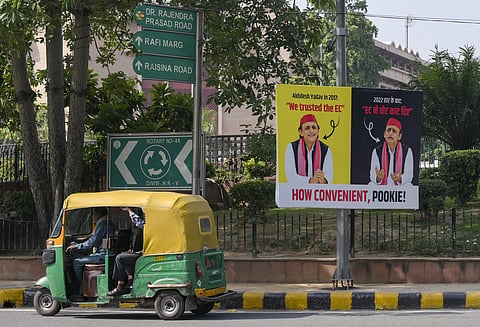 An autorickshaw moves past a poster of Lok Sabha LoP Rahul Gandhi ahead of the INDIA bloc meeting, NEW DELHI on Wednesday, September 30. (PTI Photo)
