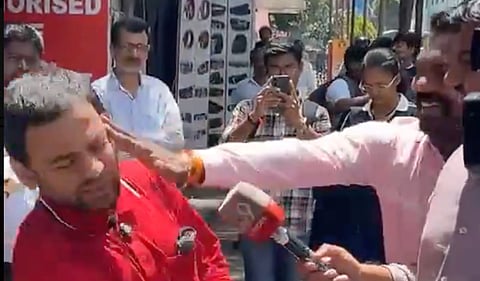 Vidyanand Bapat being assaulted while speaking to media persons in Pune. Photo: X/Screengrab
