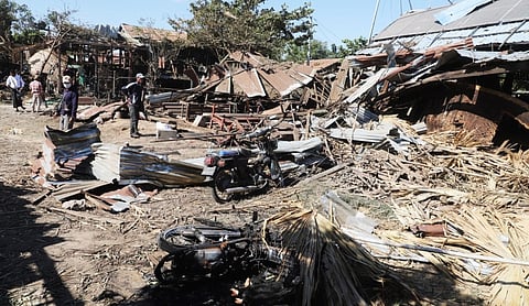 damaged houses at the site of the airstrike in Myanmar's Rakhine state, BANGKOK on Monday, September 28. (AP Photo via PTI)