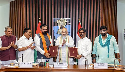Union Home Minister Amit Shah looks on as Bihar Chief Minister Samrat Choudhary and Jharkhand Chief Minister Hemant Soren display copies of the signed Sone water-sharing agreement, in New Delhi. (@samrat4bjp/X via PTI Photo)