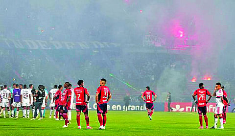 Copa Libertadores game stopped early as fans protest with flares