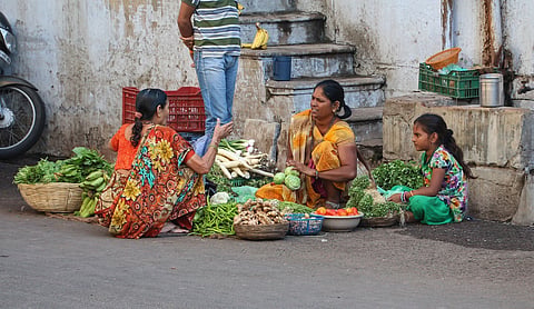 Women buy and sell vegetables at a market in Ahmedabad. Representational image. Photo: Bernard Gagnon/Wikimedia Commons (CC BY-SA 3.0).