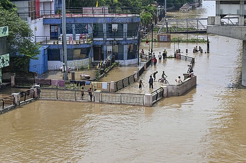 Children wade through floodwaters after the Ganga water level rose in Patna, PATNA on Sunday, September 6. (PTI Photo)