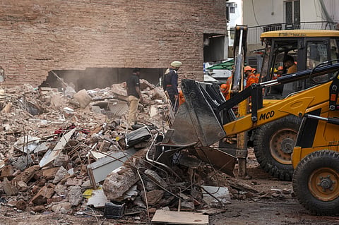 An excavator clears debris during a rescue operation after the Satya Niketan building collapse in New Delhi, NEW DELHI on Monday, September 7. (PTI Photo)