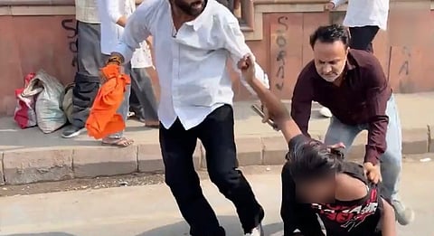 A screengrab from a video appears to show two men hitting and physically assaulting a protester during the CJP protest in Delhi. Image source: X