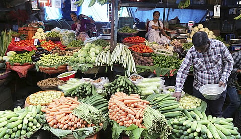 Representational image: Customers shop for vegetables at a market in Thane. (PTI Photo)