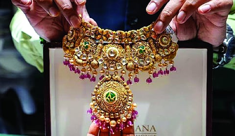 Gold slides Rs 500 as oil surges, strong US dollar weigh on bullion