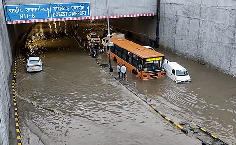 File photo: Vehicles stand in water inside the Delhi airport tunnel after heavy rain. (Screengrab via PTI), NEW DELHI.
