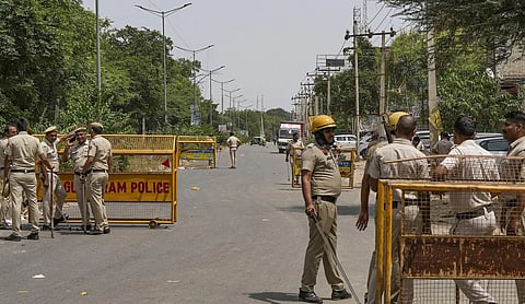 File photo: Gurugram Police personnel at a barricaded road. (PTI Photo)