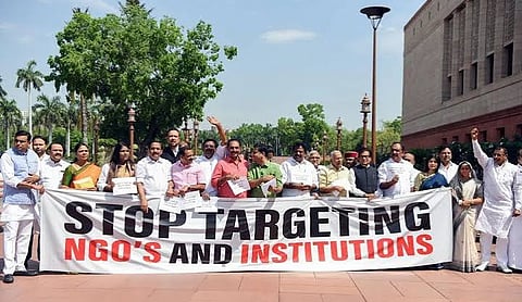 Representational image: Protesters hold a banner reading 'Stop targeting NGOs and institutions' during a demonstration in New Delhi. (PTI Photo)