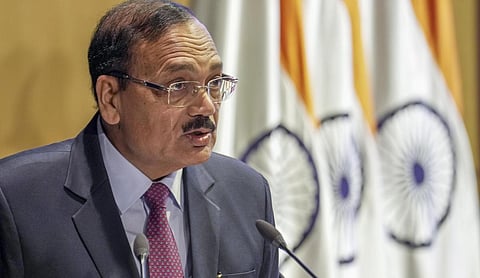 File photo: CJI Surya Kant speaks into a microphone against a backdrop of flags, NEW DELHI. (PTI Photo)