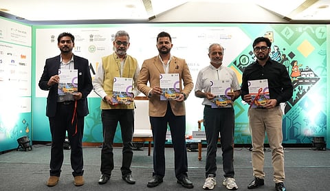 Participants hold copies of the ICCT and MANIT study on electrifying urban public fleets at Urban Adda 2026 in New Delhi.