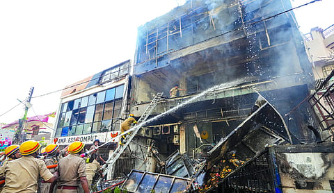 Fire personnel conduct a dousing operation after fire broke out at a commercial building in Aliganj, Lucknow PTI