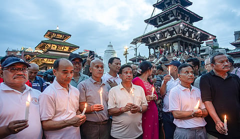 People take part in a candlelight vigil at the premises of the UNESCO World Heritage Site, Basantapur Durbar Square, marking the 13th day since flash floods and a mudslide in the country, in Kathmandu, Nepal, Monday, Sept. 7, 2026. PTI Photo