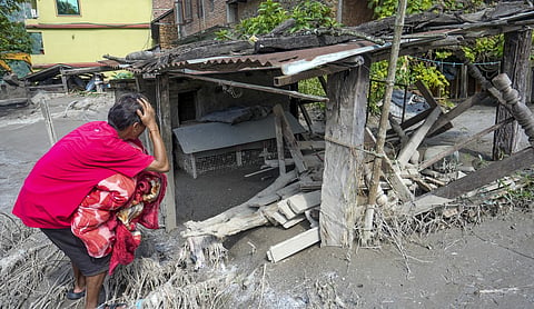 A resident reacts while looking at a house damaged by flash floods and landslides, in Dhading district, Nepal, Saturday, August 29. (PTI Photo)