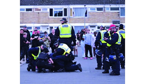 Police officers bitten during anti-migrant protests in UK town