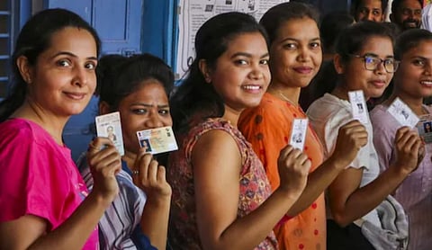 Voters queue at a polling station during Rajasthan urban local body elections. 