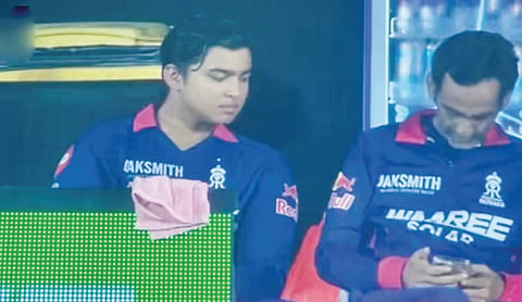 RR manager uses phone in dugout