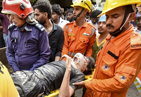 NDRF personnel carry a student rescued from the debris of the collapsed building in Satya Niketan, New Delhi, NEW DELHI on Sunday, September 6. (PTI Photo)