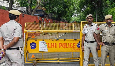 Representational image: Delhi Police personnel stand guard near a yellow barricade on a street. (PTI Photo)