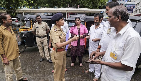 Representational image: A police official interacts with auto-rickshaw drivers. (PTI Photo)