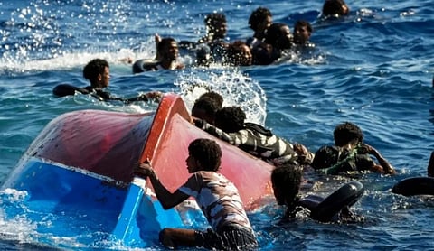 Migrants cling to the hull of an overturned boat in the Mediterranean Sea after the vessel carrying them capsized off Tunisia's coast.