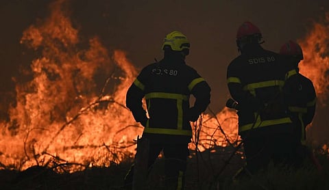 Wildfires in France drive 250,000 people from their homes, creep toward wine city