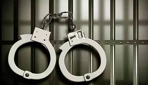 Representational image: A pair of handcuffs hanging on bars. (PTI Photo)
