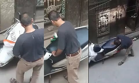 தேசியக்கோடியை 'பைக்' துடைக்கும் துணியாக பயன்படுத்திய நபர்