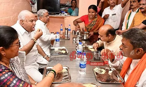 தலித் வீட்டில் உணவு சாப்பிட்ட பசவராஜ் பொம்மை-எடியூரப்பா; தேர்தல் நாடகம் என காங்கிரஸ் விமர்சனம்