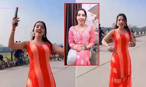 கையில் துப்பாக்கியுடன் இளம்பெண் நடுரோட்டில் ஆட்டம்... வைரலான வீடியோ