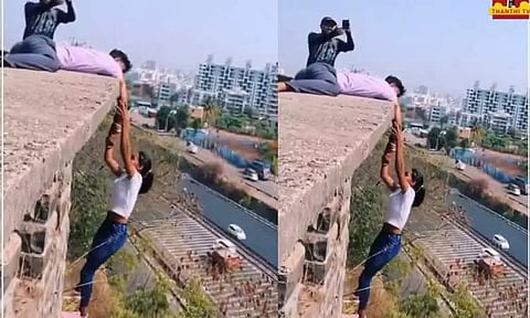 ஆபத்தை உணராமல் உயரமான கட்டிடத்தில் தொங்கியபடி ரீல்ஸ்... இளம்பெண் உட்பட 5 பேர் மீது வழக்குப்பதிவு