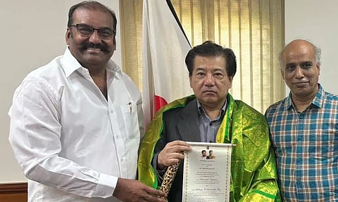 Napoleon presenting his son's wedding invitation to the Indian Ambassador of Japan