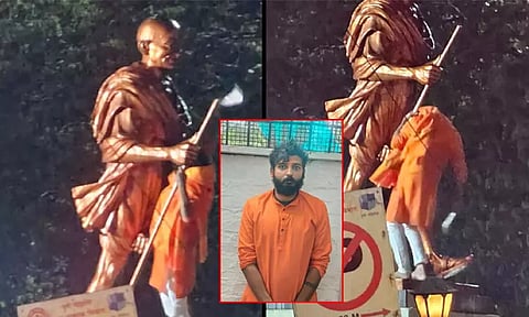 ரெயில் நிலையத்தில் காந்தி சிலையை உடைக்க முயன்ற நபர்; பரபரப்பு சம்பவம்