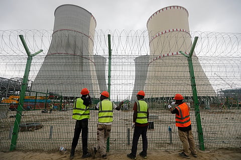 An AP file photo shows workers fix barbed wire on the fence of the Rooppur Nuclear Power Plant at Ishwardi in Pabna, Bangladesh, October 4, 2023.
