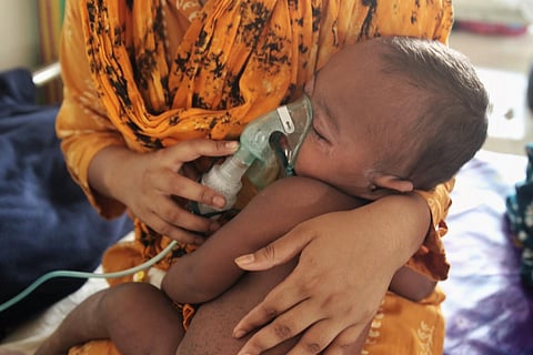 A mother taking care of her baby in a hospital.