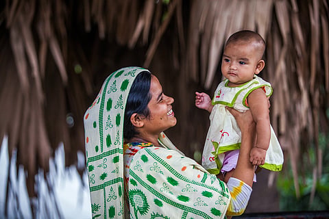 A woman smiles at her baby in a village near Dhaka recently.