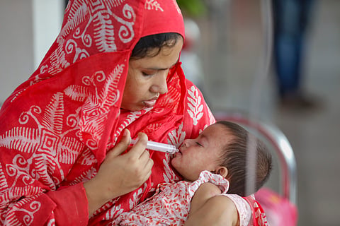 A mother is taking care of her ill baby at DNCC hospital on May 12, 2026. 