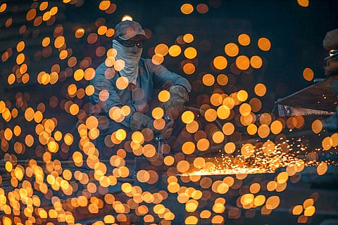 A man works in a wielding factory in Dhaka