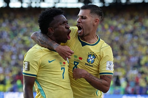 Brazil's Vinicius Junior celebrates with teammate Bruno Guimaraes after scoring during their World Cup Group C match against Morocco in New Jersey on Sunday. 