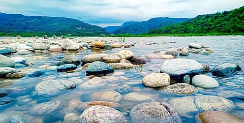 White stones lie beneath the clear waters of Sylhet's popular tourist destination Sada Pathor.