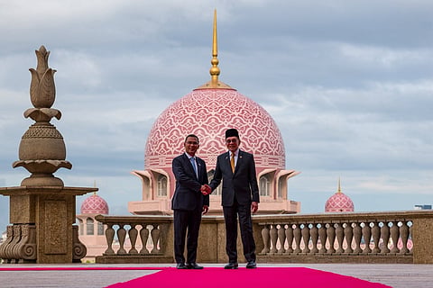 Prime Minister Tarique Rahman and his Malaysian counterpart Anwar Ibrahim against the backdrop of Putra Mosque in Malaysia's Putrajaya. 